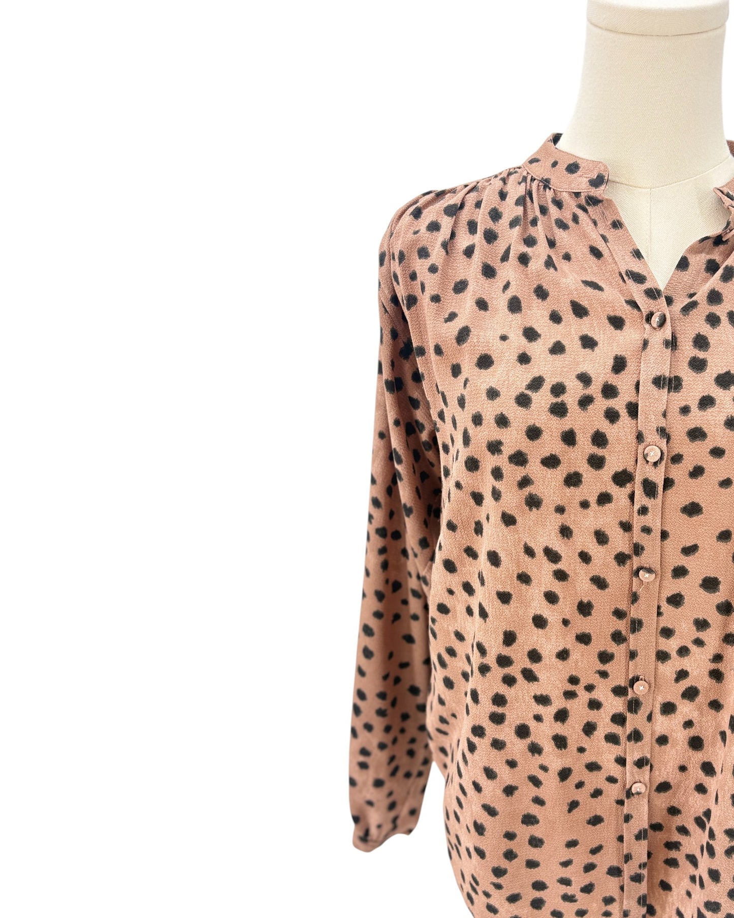 Brown shirt with black animal print pattern on a mannequin against a white background