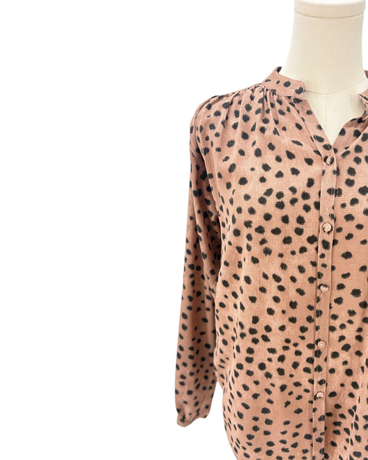 Brown shirt with black animal print pattern on a mannequin against a white background