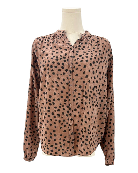 Brown shirt with black animal print pattern on a mannequin against a white background