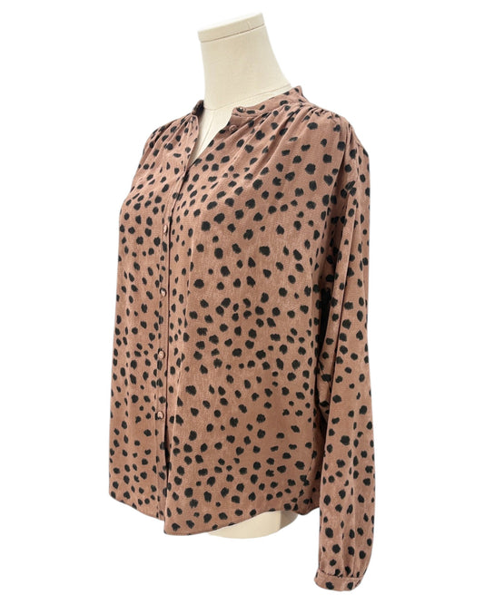 Brown shirt with black animal print pattern on a mannequin against a white background