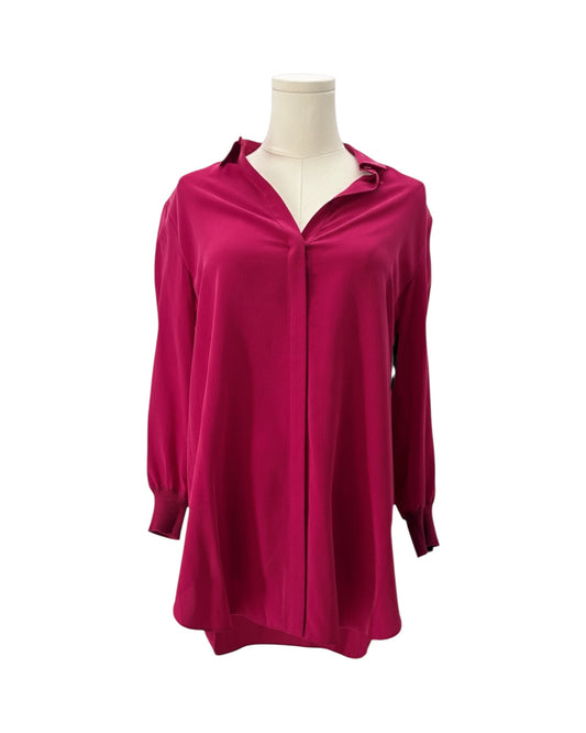 Pink blouse on a mannequin against a white background
