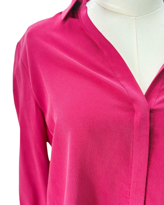 Pink blouse on a mannequin with a white background