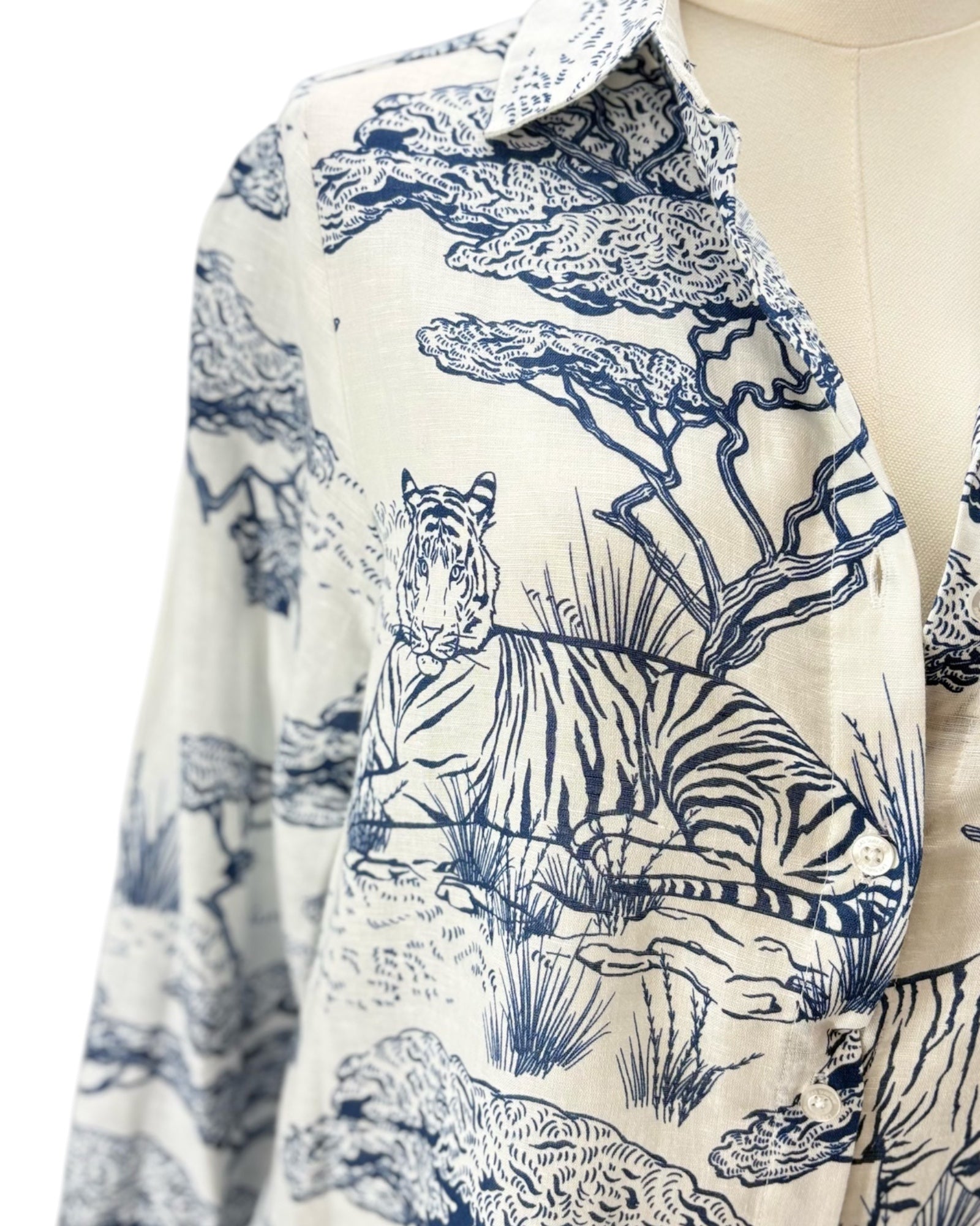 White dress with blue floral pattern on a mannequin against a white background