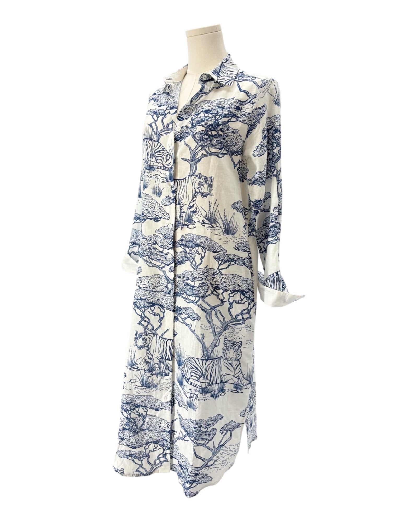 White dress with blue floral pattern on a mannequin against a white background