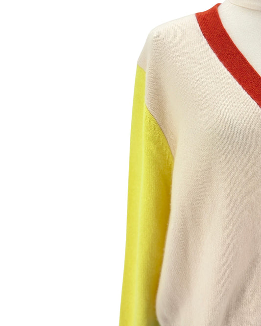 Color-blocked sweater with red, yellow, and beige sections on a white background