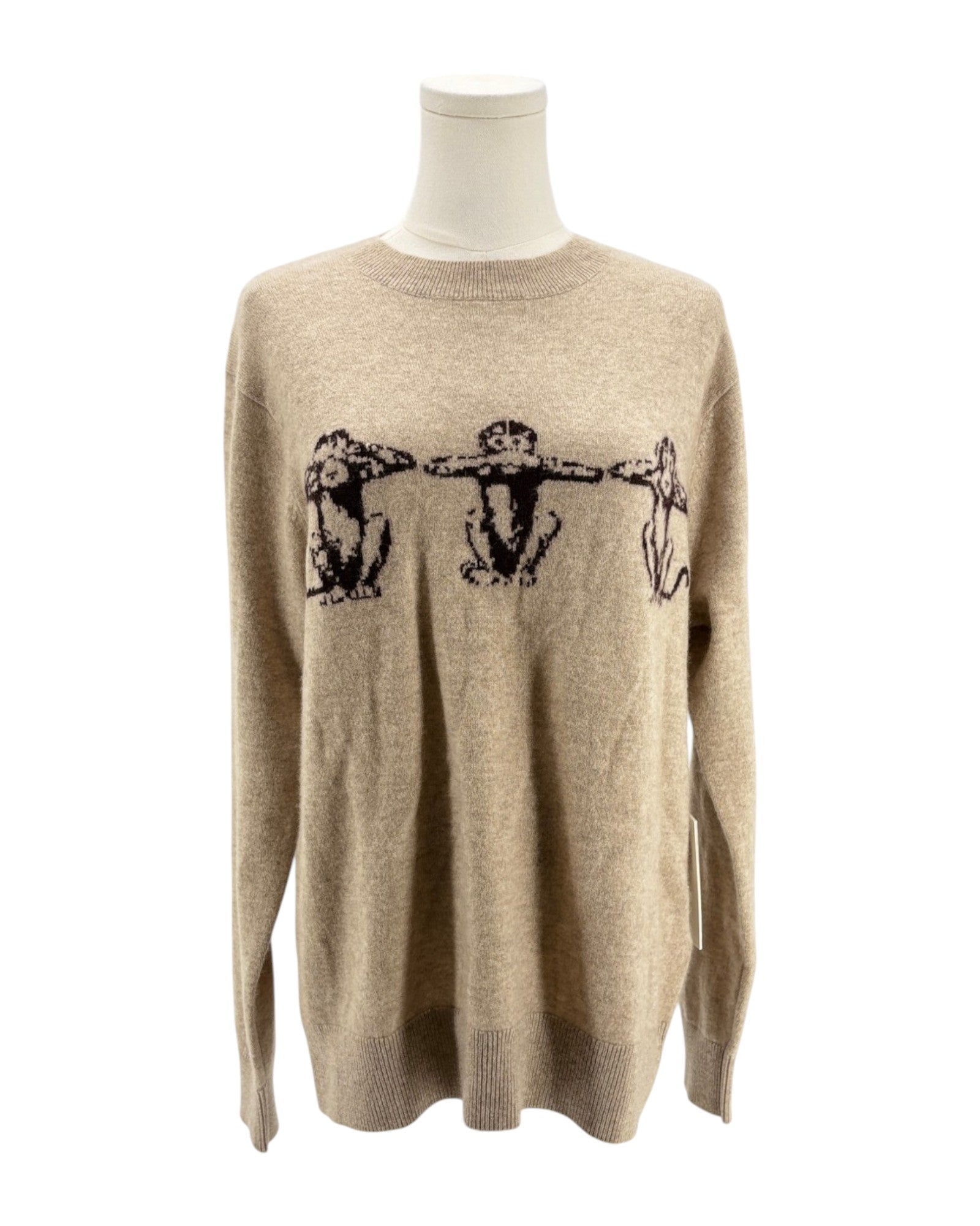 Beige sweater with black graphic design on a mannequin against a white background