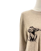 Beige sweater with a black and white design on a white background