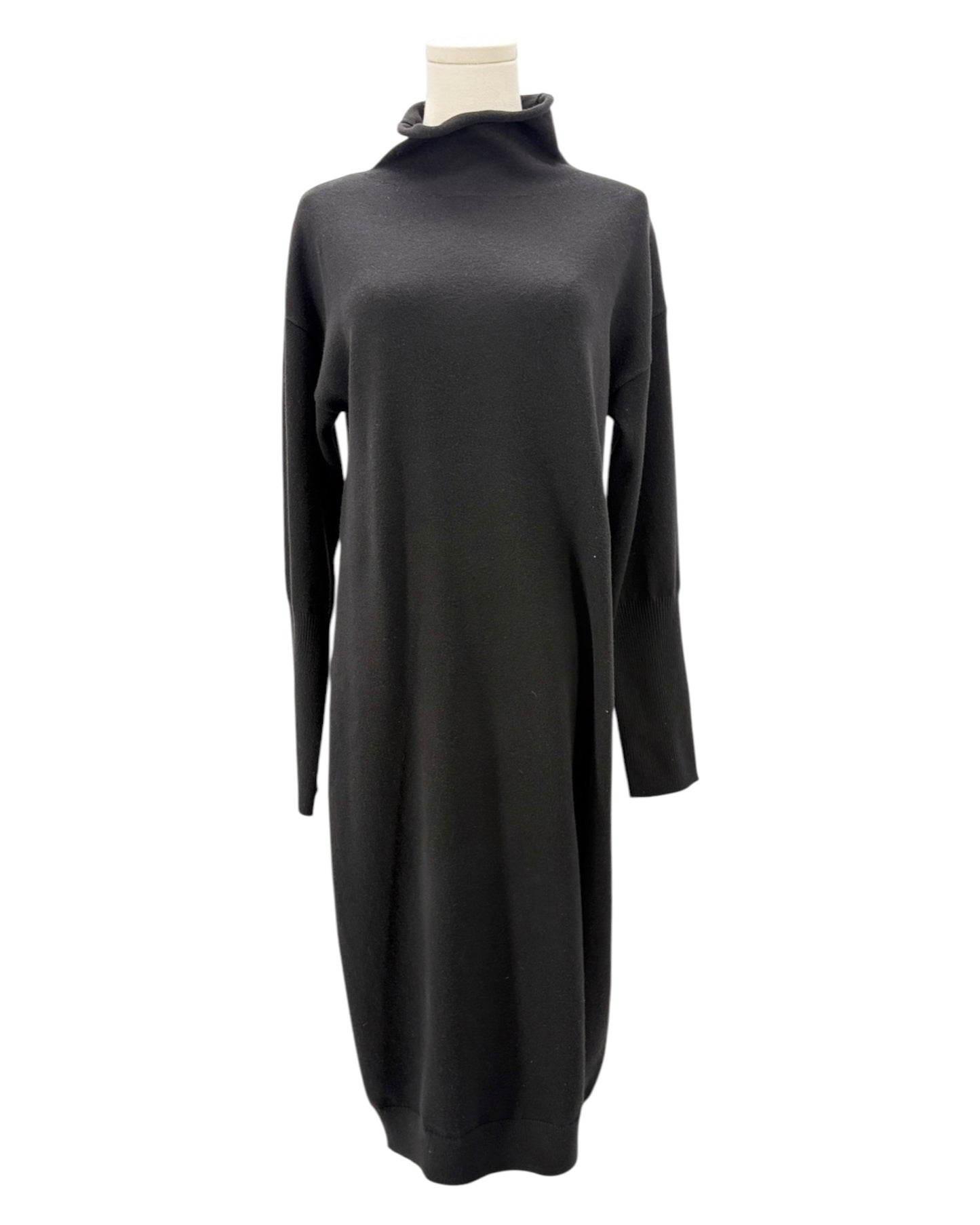 Black sweater dress on a mannequin against a white background
