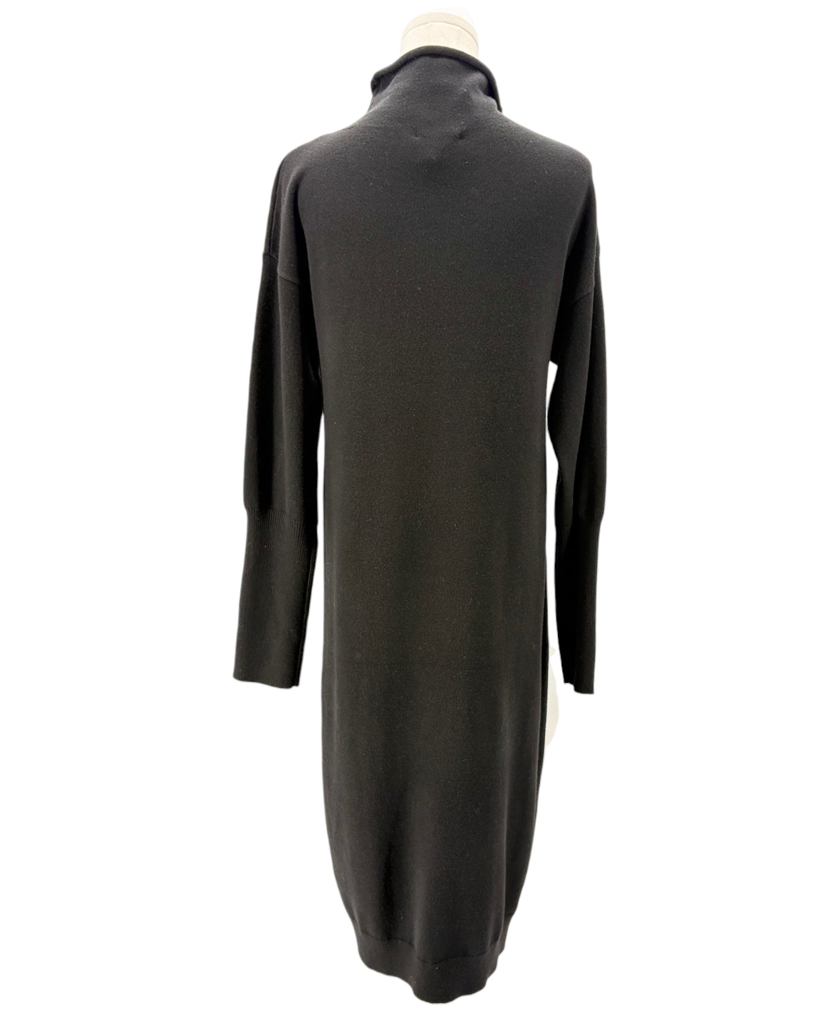 Black sweater dress on a mannequin against a white background