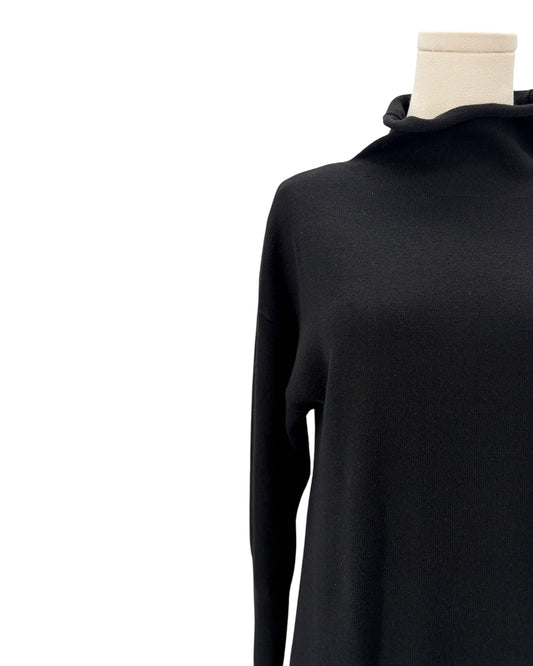 Black sweater dress on a mannequin against a white background