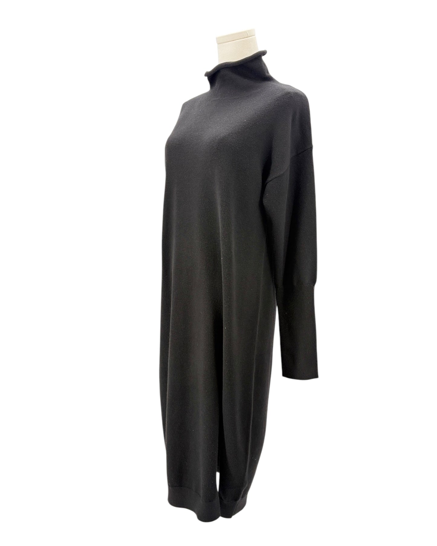 Black sweater dress on a mannequin against a white background