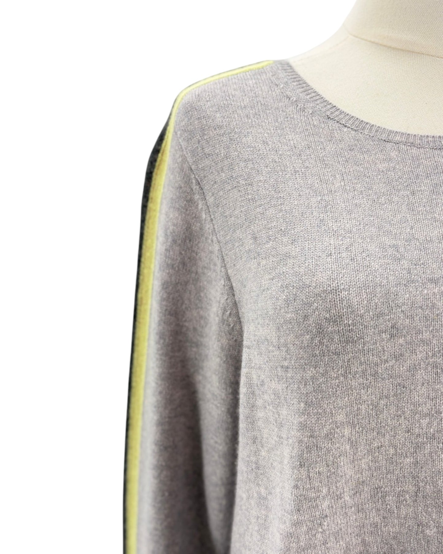 Gray sweater with yellow trim on a mannequin against a white background