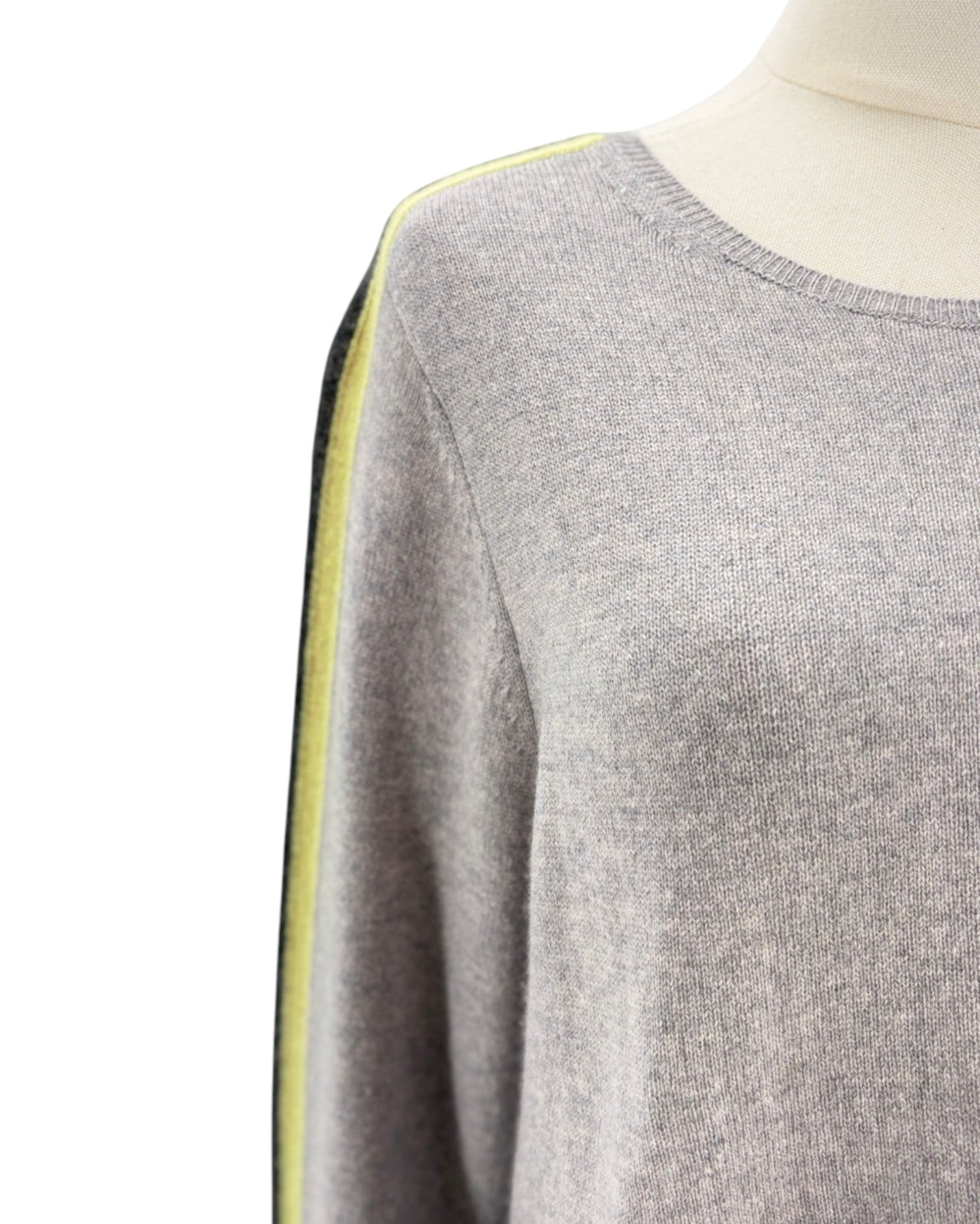 Gray sweater with yellow trim on a mannequin against a white background