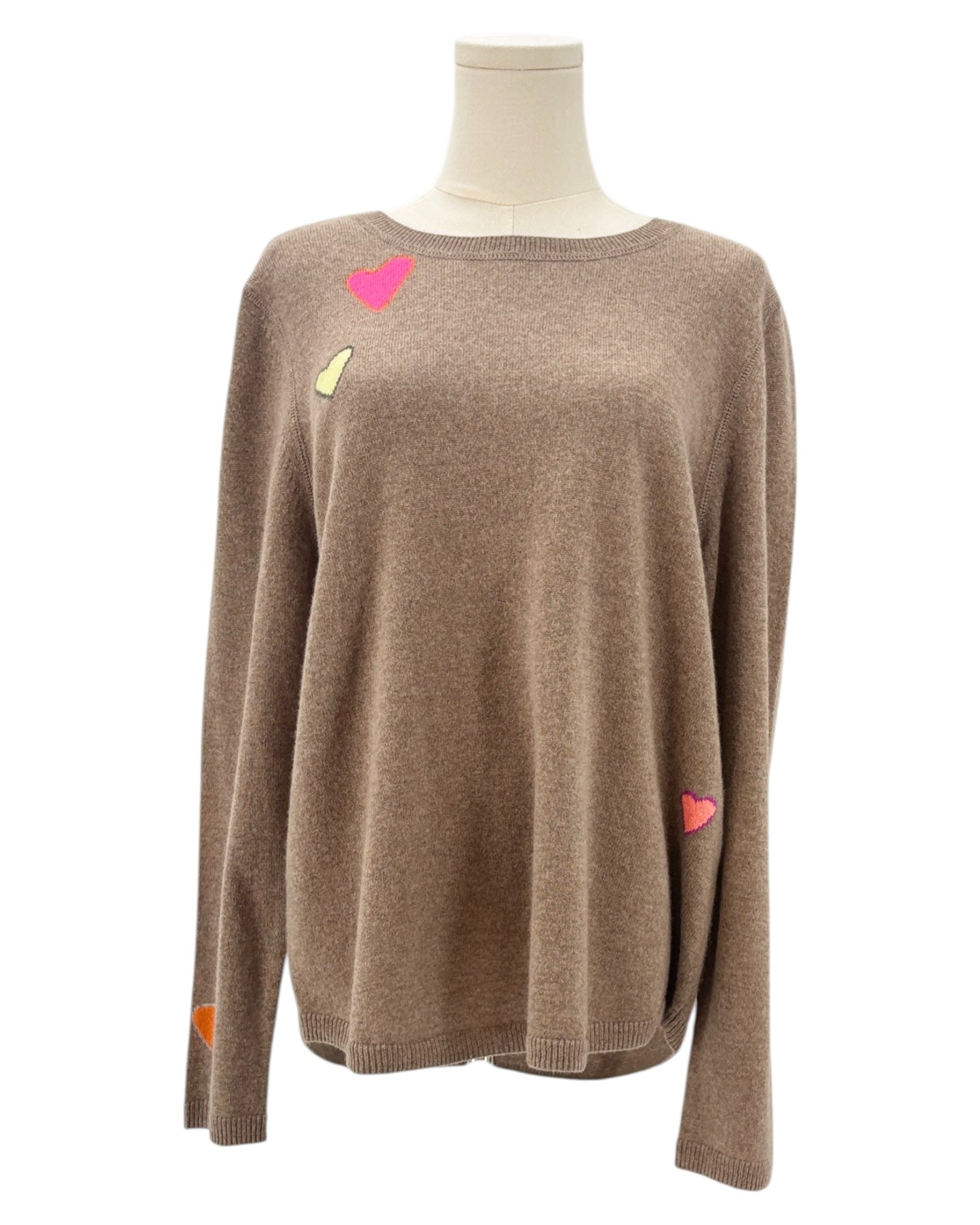 Tan sweater with colorful heart patterns on a mannequin against a white background