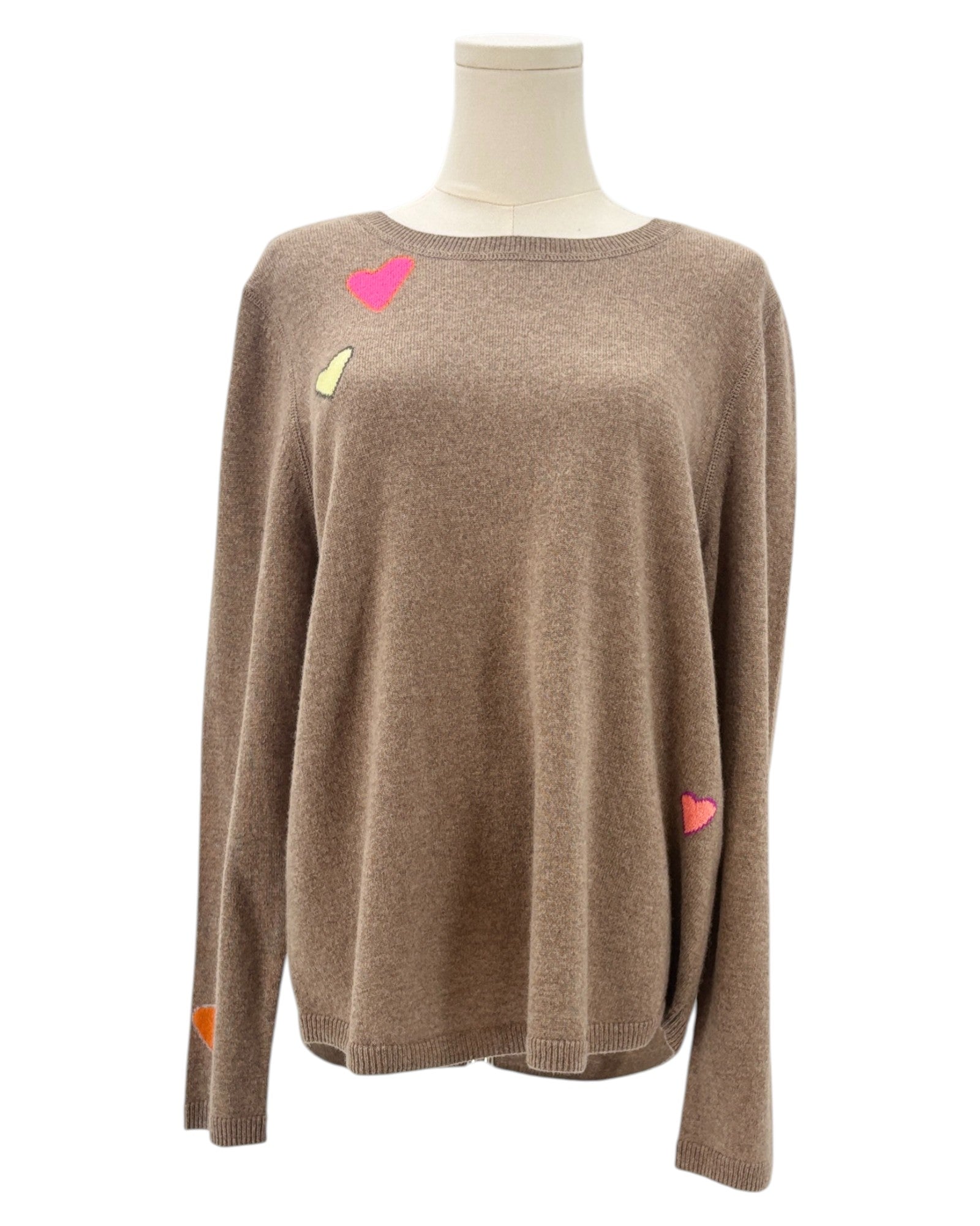 Tan sweater with colorful heart patterns on a mannequin against a white background