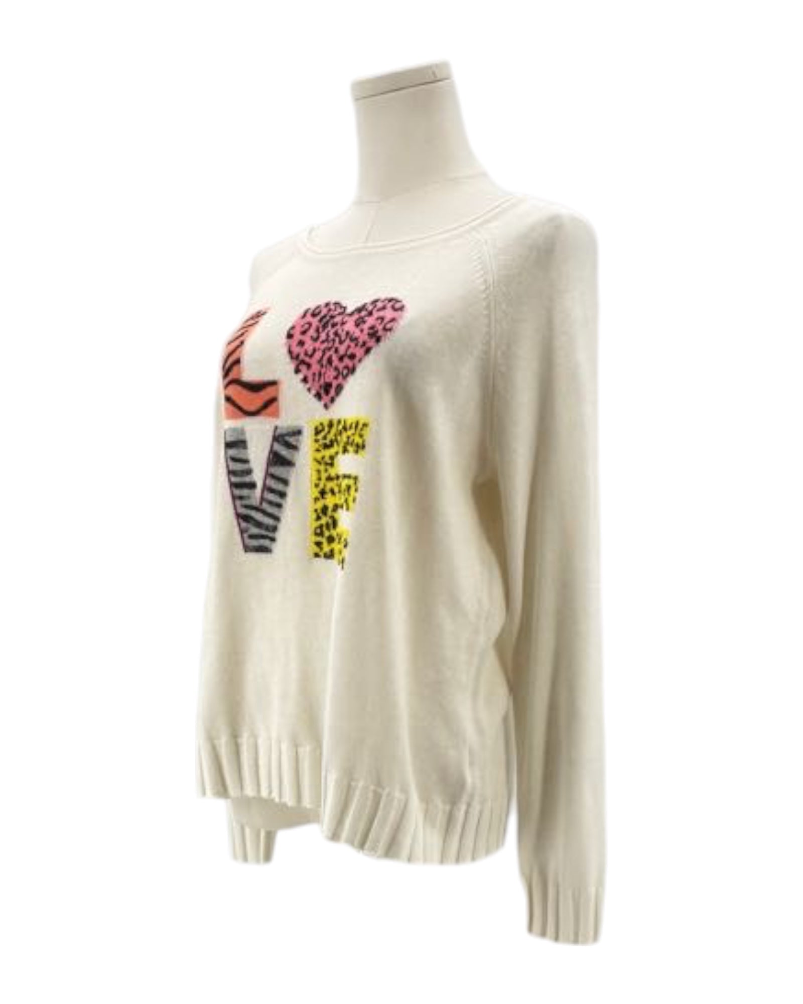 White sweater with colorful heart designs on a mannequin against a white background