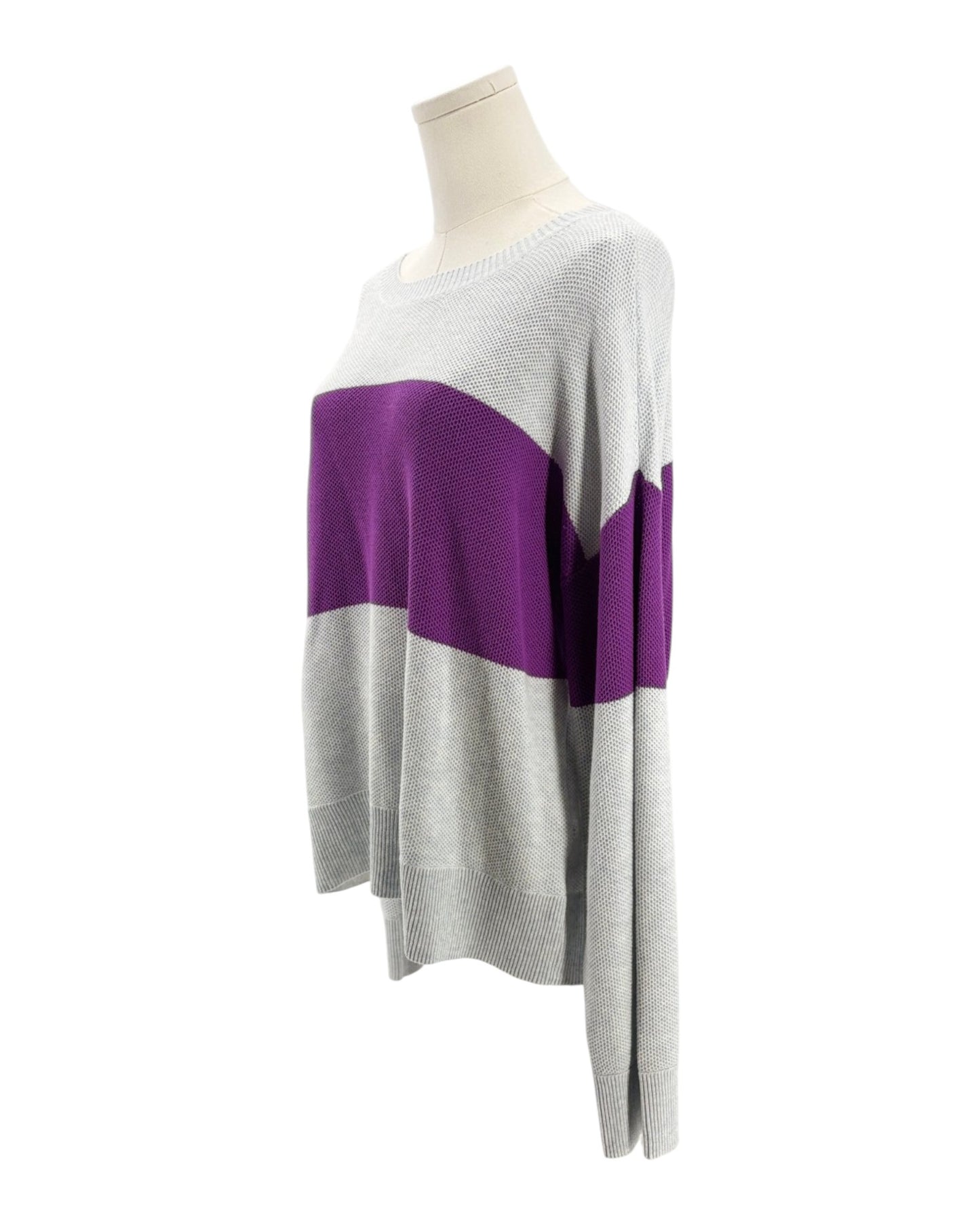 Color-blocked sweater on a mannequin against a white background