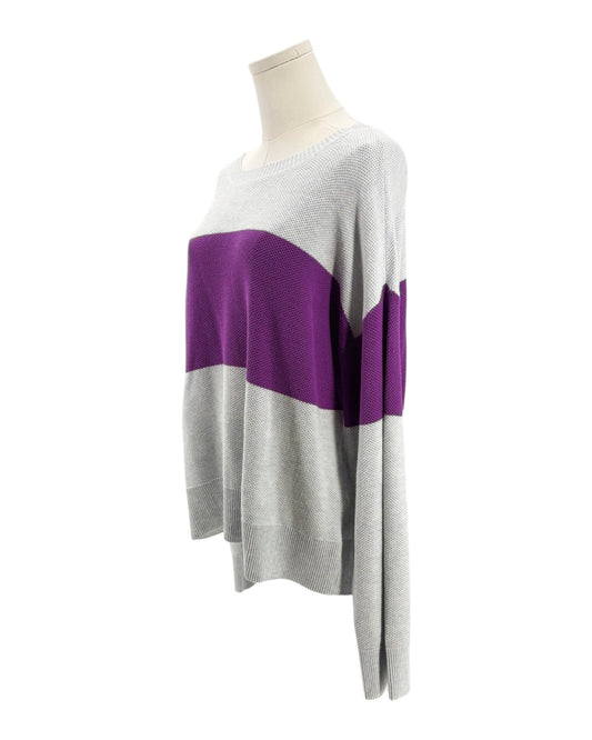 Color-blocked sweater on a mannequin against a white background
