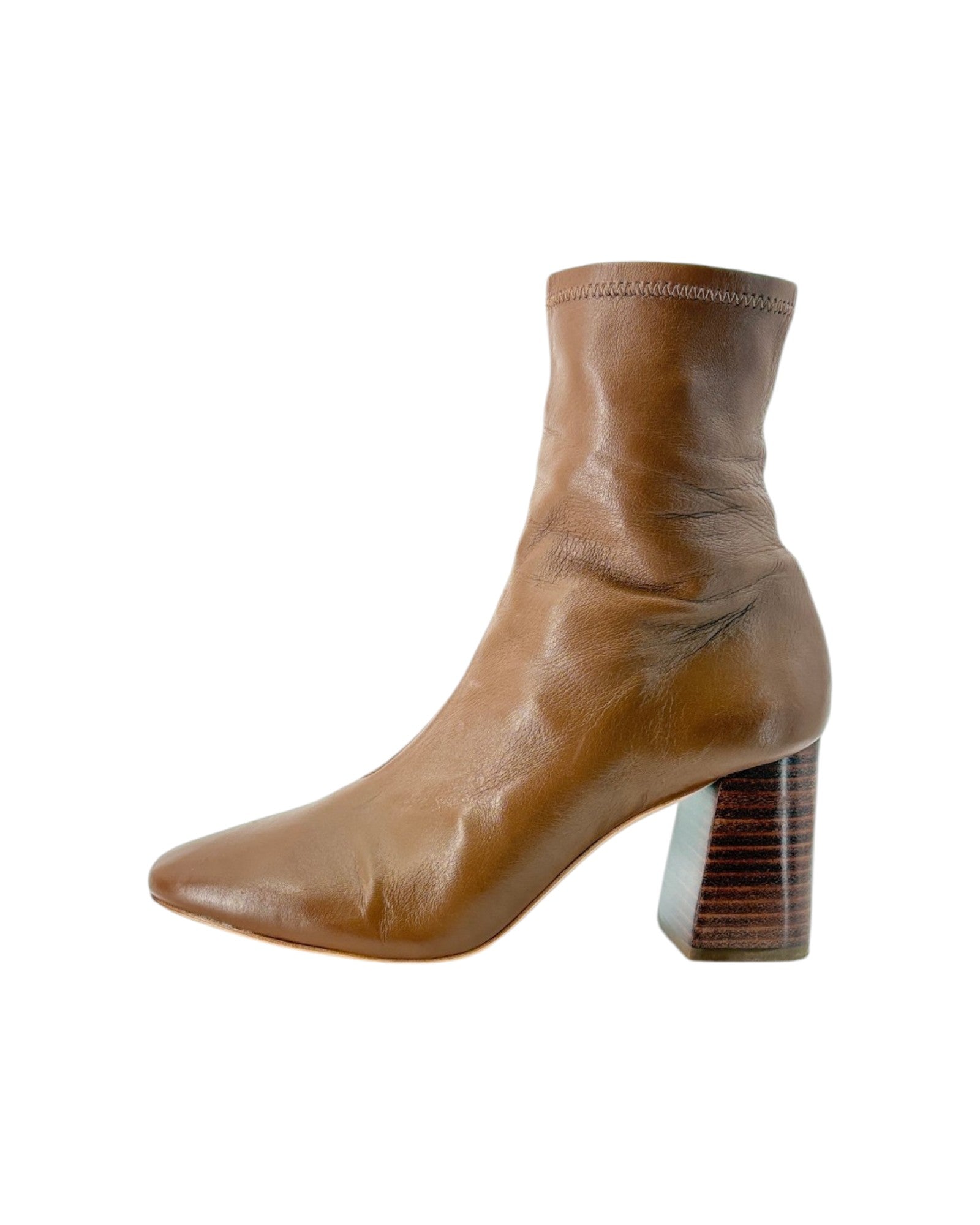 Tan leather ankle boot with a block heel on a white background