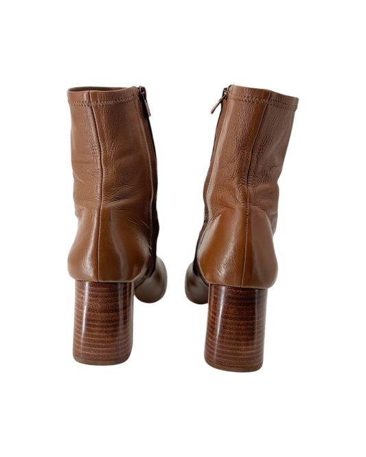 Pair of brown leather boots on a white background