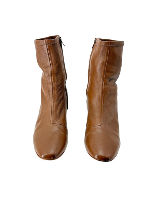 Pair of brown leather boots on a white background