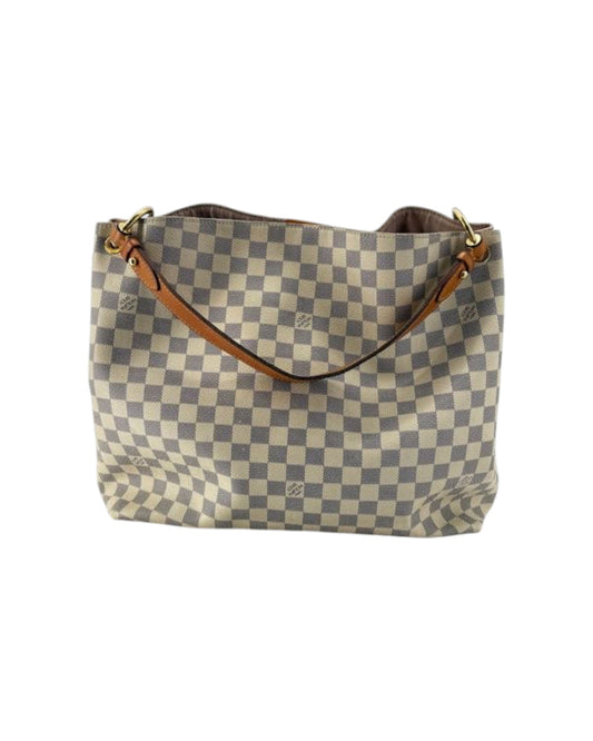 Checkered handbag with brown handles on a white background
