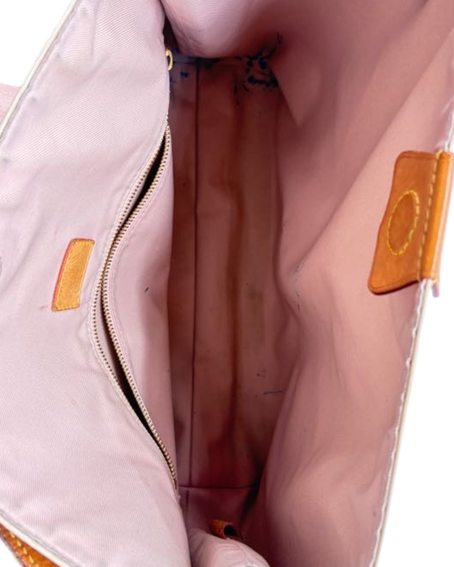 Close-up of a pink bag with a visible brand logo on a white background
