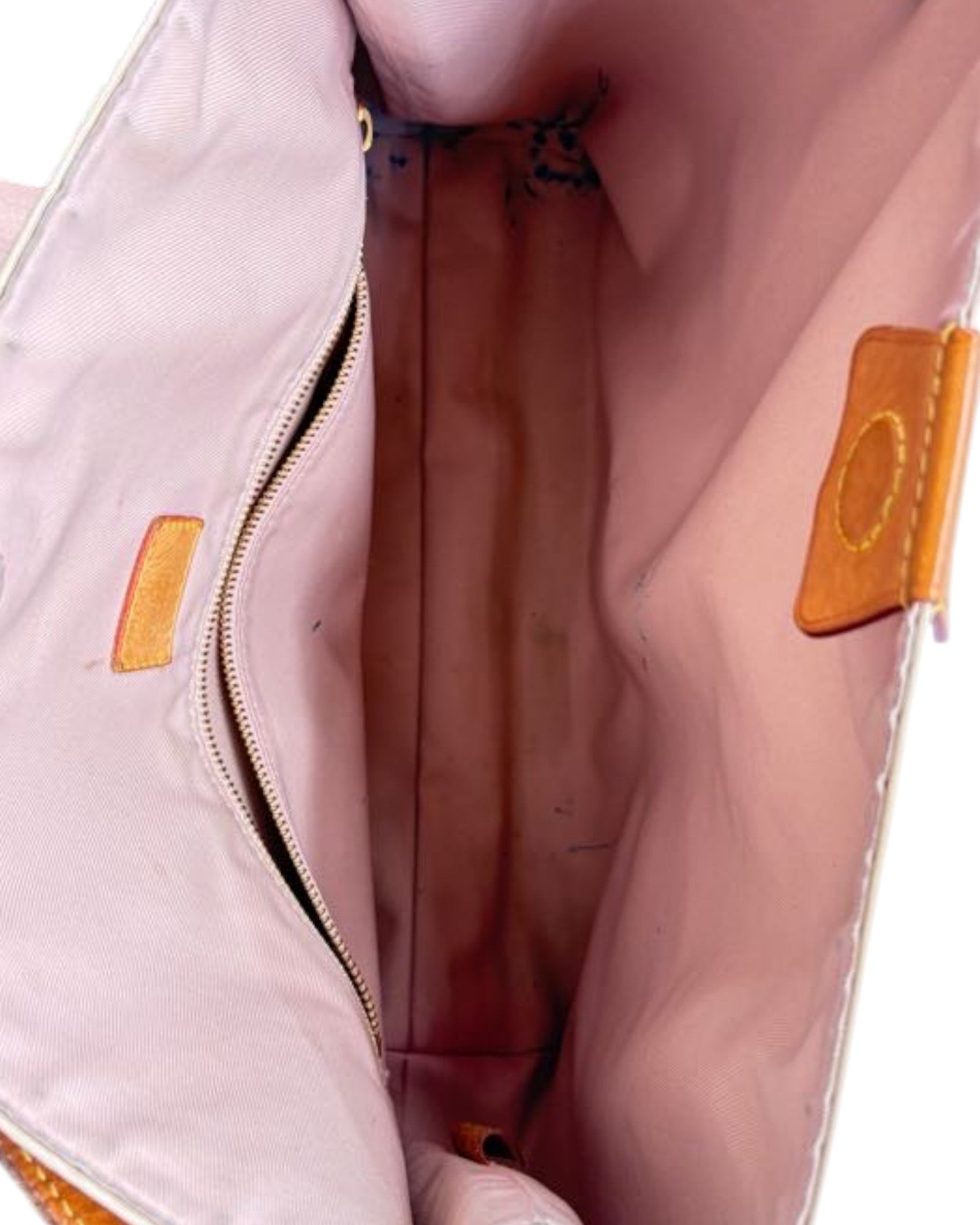 Close-up of a pink bag with a visible brand logo on a white background