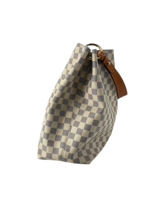 Checkered bag with a brown strap on a white background