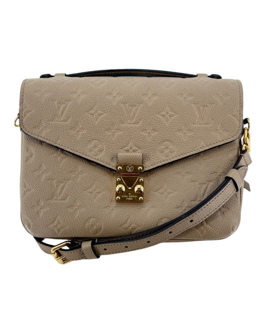 Beige leather Louis Vuitton Handbag with gold hardware on a white background
