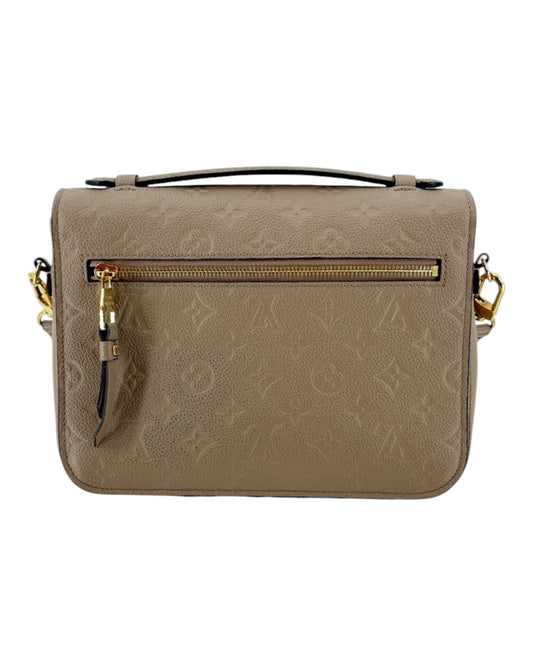 Beige leather Louis Vuitton Handbag with gold hardware on a white background