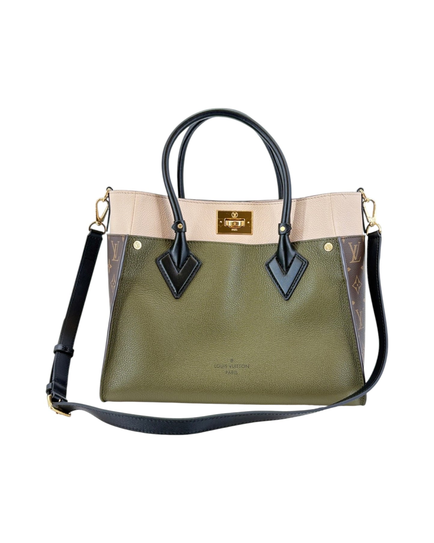 Green handbag with beige accents and black straps on a white background