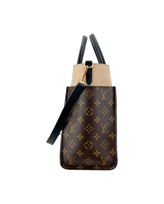 Designer handbag with monogram pattern on a white background