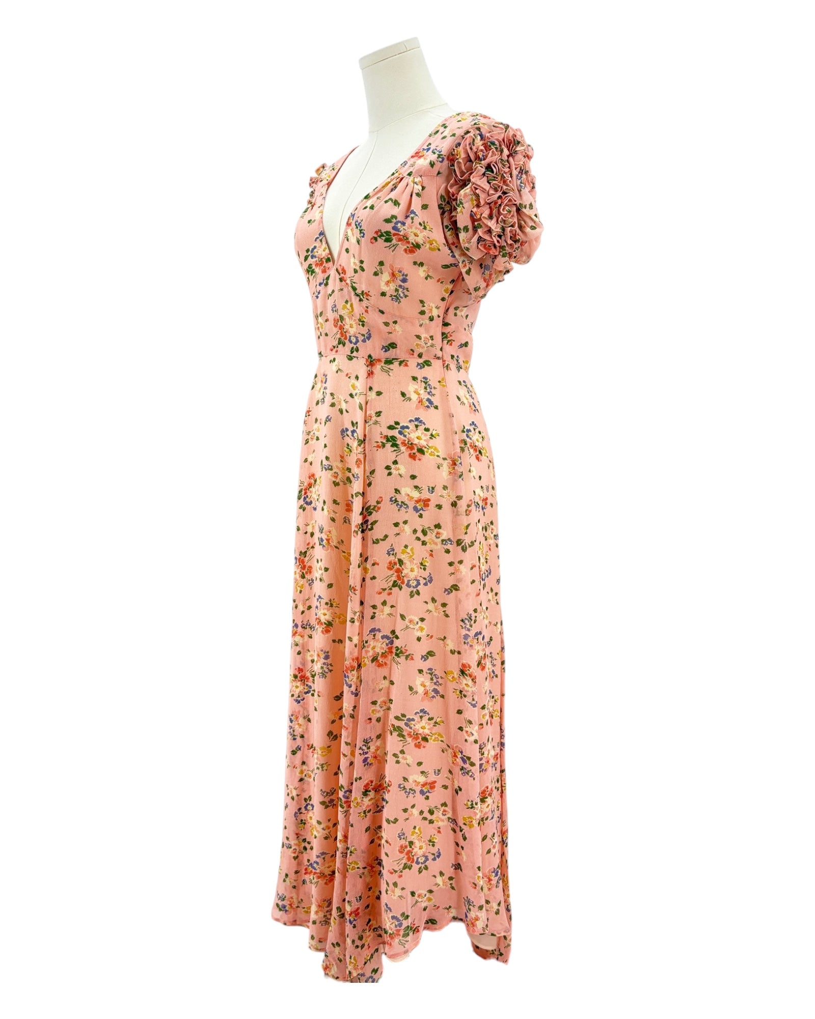 Floral dress on a mannequin against a white background