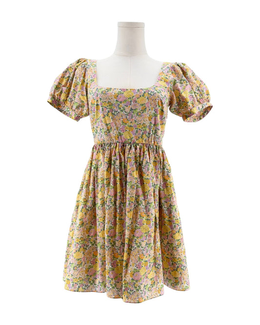 Floral dress on a mannequin against a white background