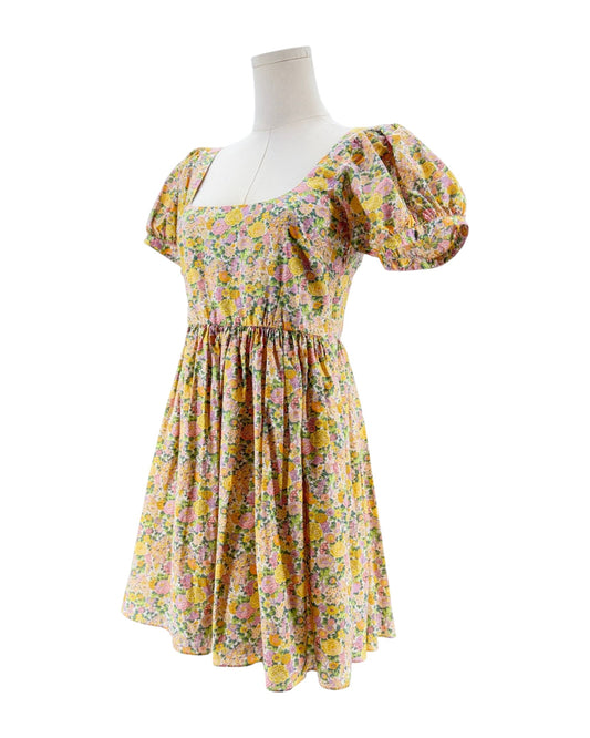 Floral dress on a mannequin against a white background