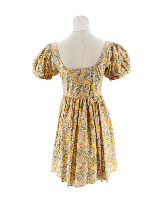 Floral dress on a mannequin against a white background