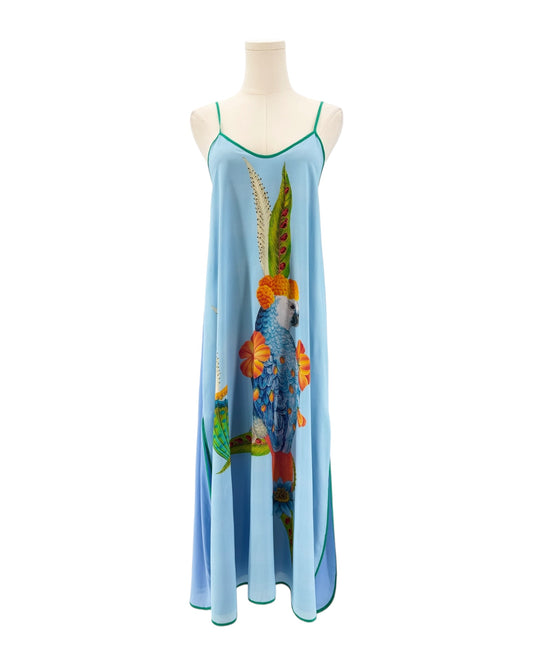 Mannequin wearing a long, light blue dress with colorful fish design on a white background