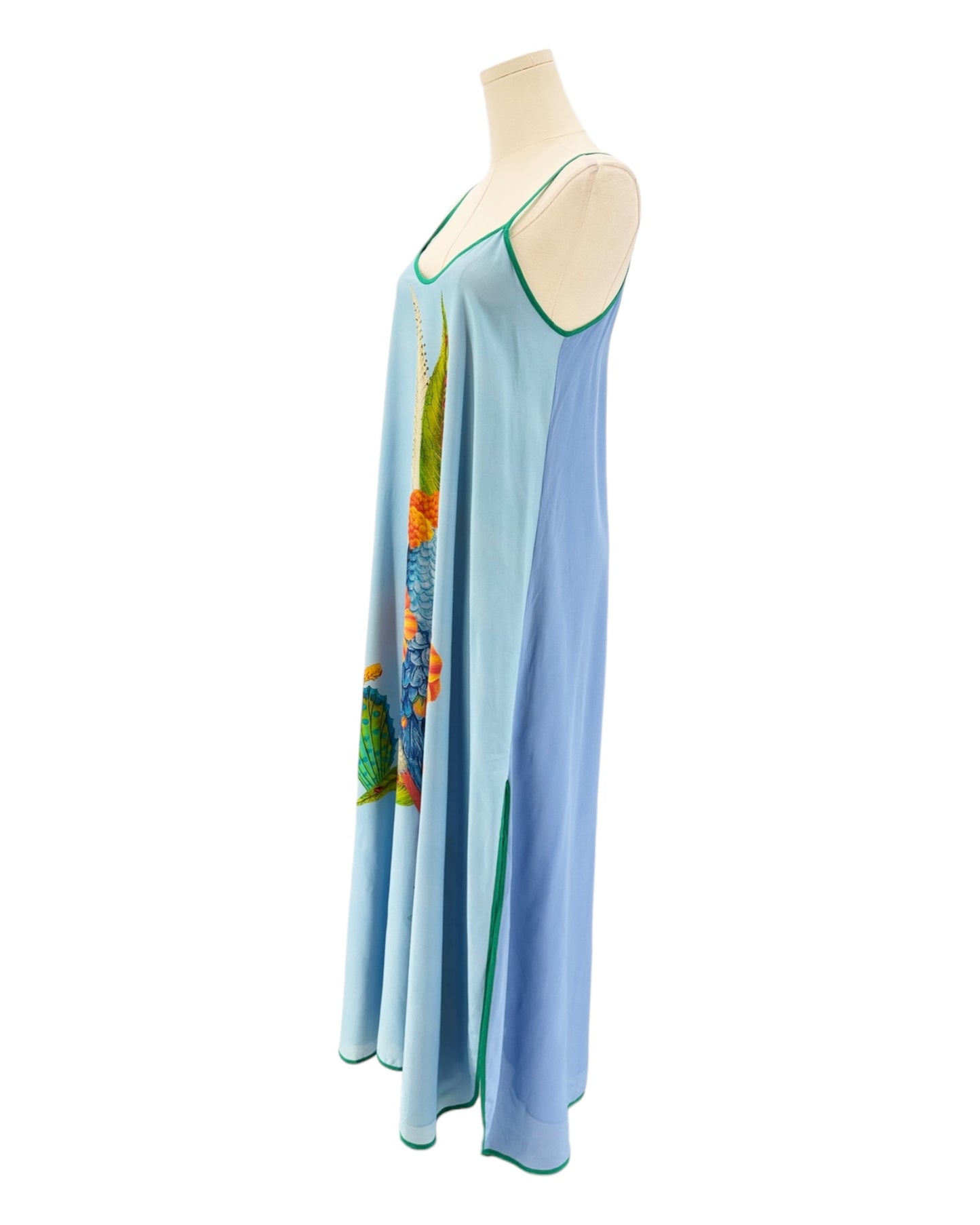 Light blue dress with colorful design on a mannequin against a white background