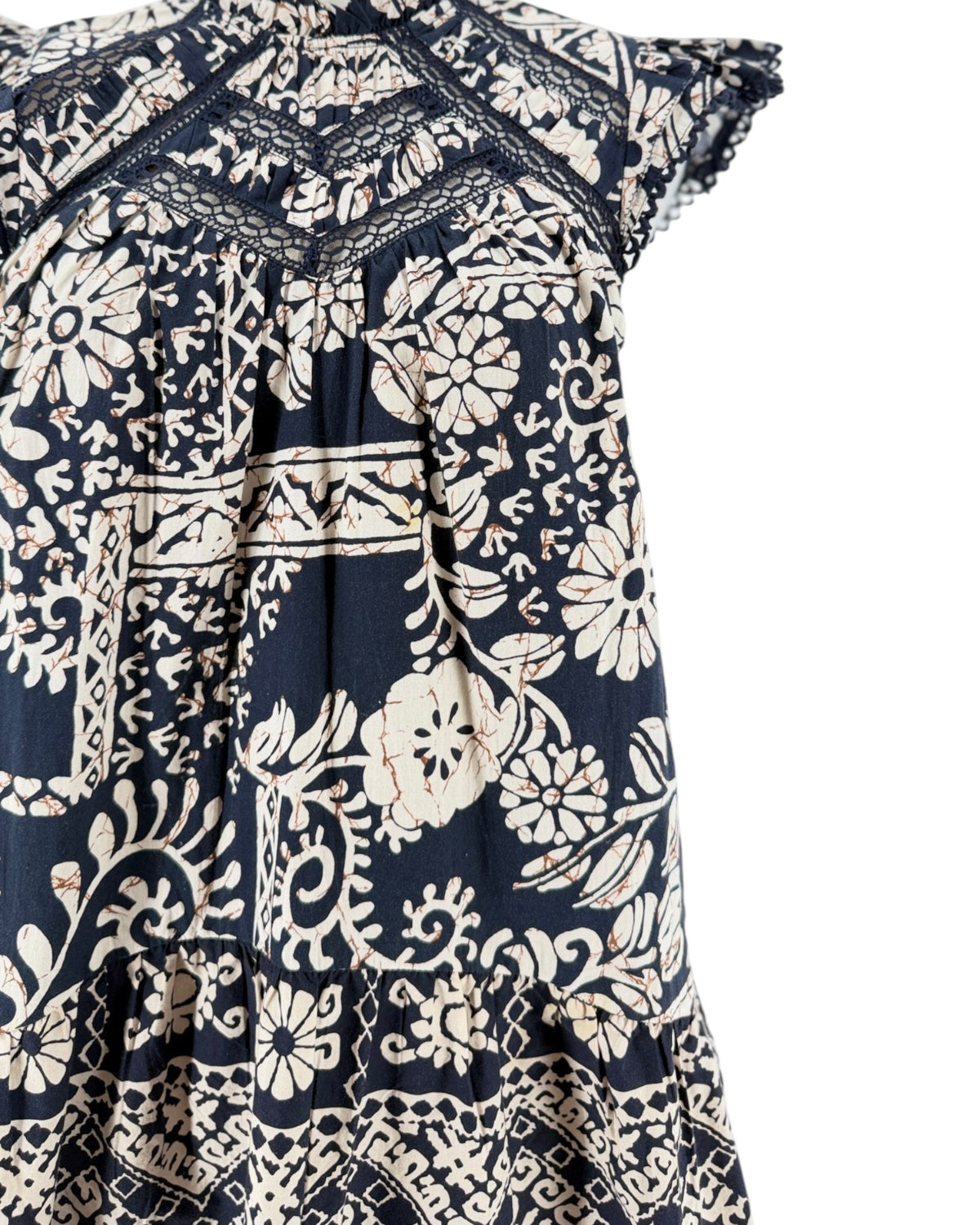 A navy blue and cream floral print dress displayed on a mannequin torso against a plain white background.