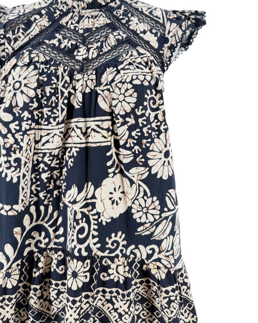 A navy blue and cream floral print dress displayed on a mannequin torso against a plain white background.