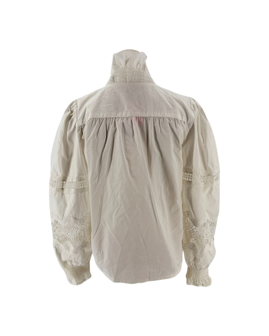 White long sleeve blouse with a ruffle collar and eyelet detailing on the sleeves on a mannequin on a white background