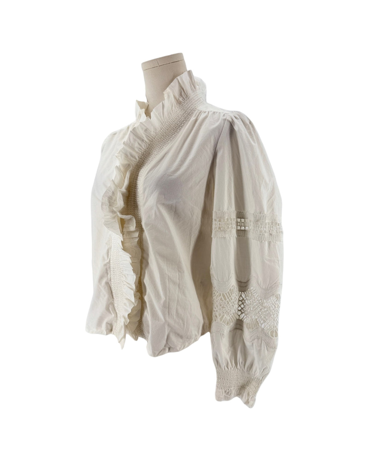 White long sleeve blouse with a ruffle collar and eyelet detailing on the sleeves on a mannequin on a white background