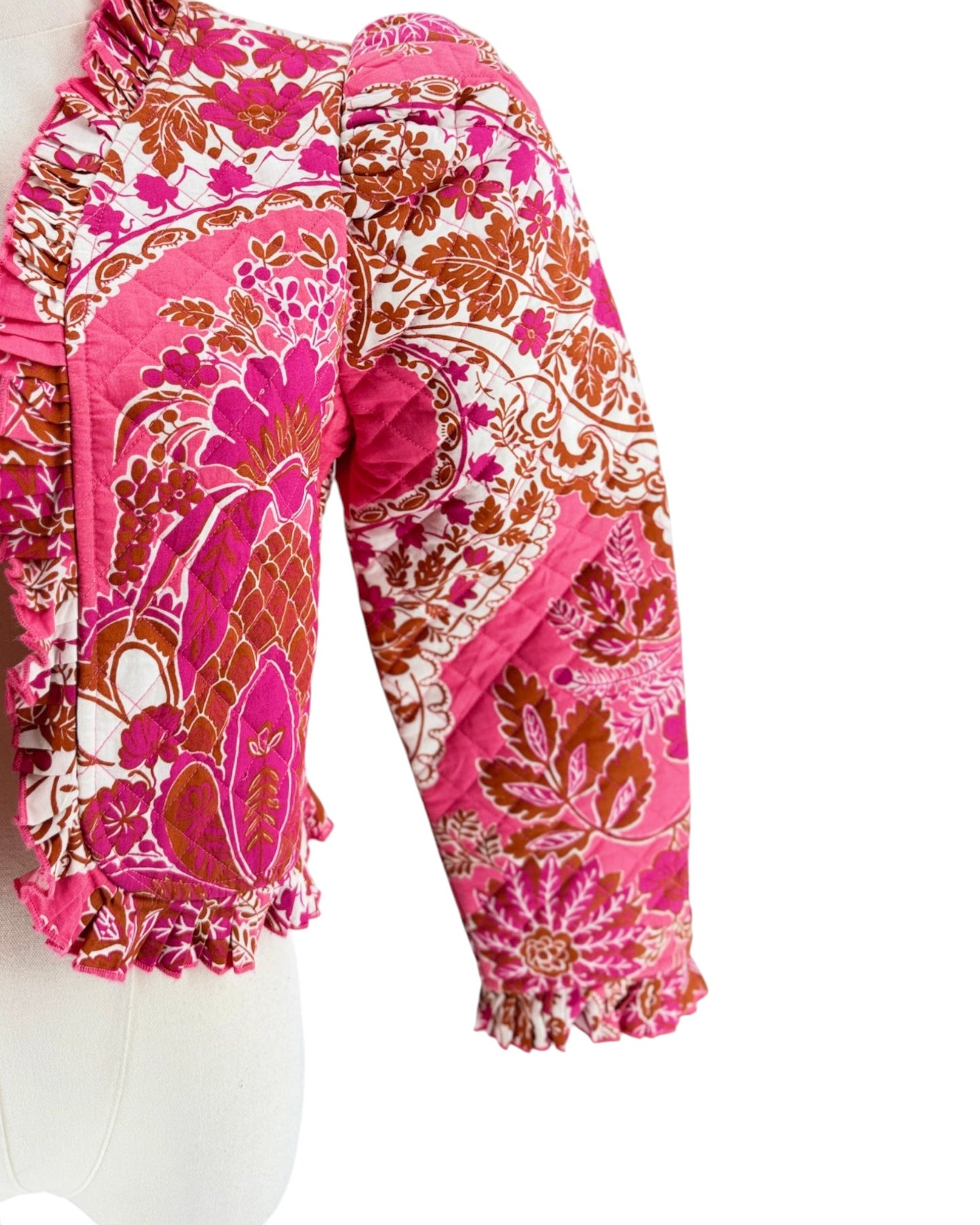 Long sleeve floral pink quilted jacket with ruffle trim on a white background