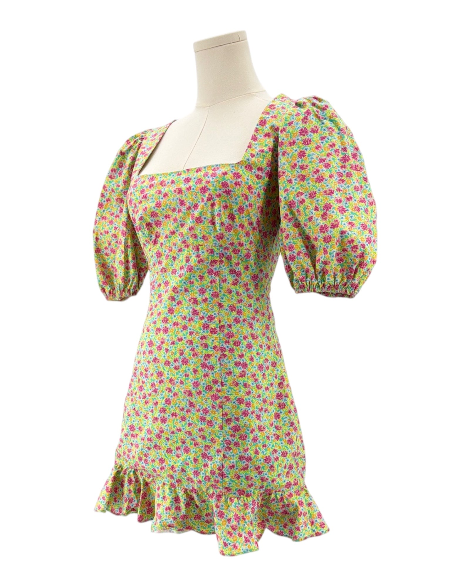 Floral dress on a mannequin against a white background