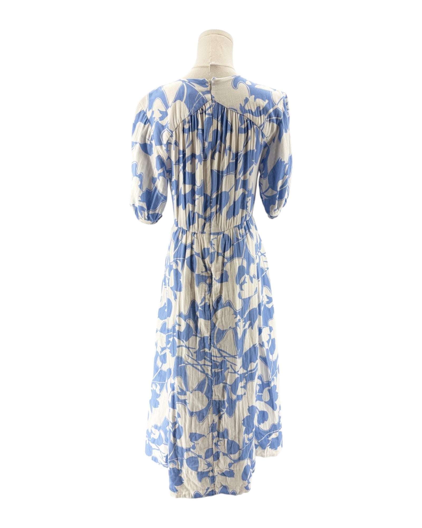 Blue and white floral dress on a mannequin against a white background