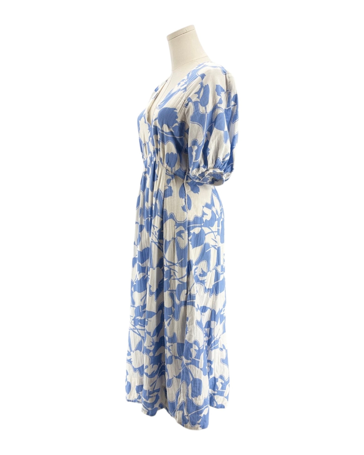 Blue and white floral dress on a mannequin against a white background
