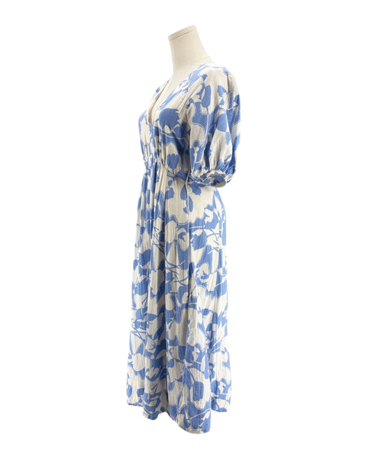 Blue and white floral dress on a mannequin against a white background