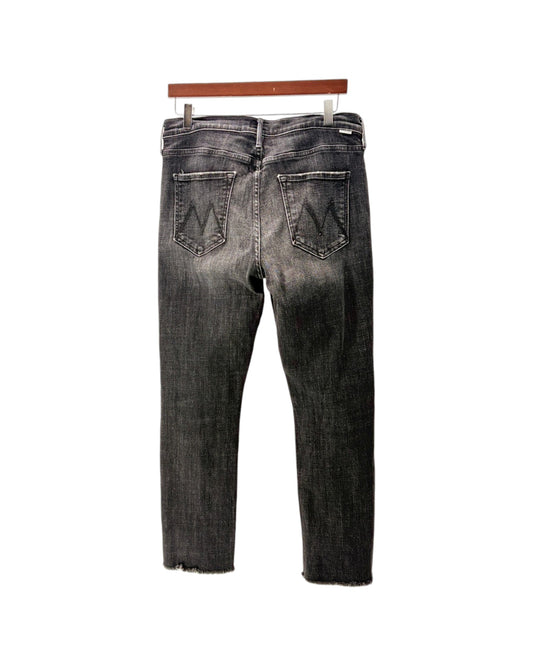 Back view of a pair of dark gray washed denim jeans hanging on a wooden hanger against a white background.