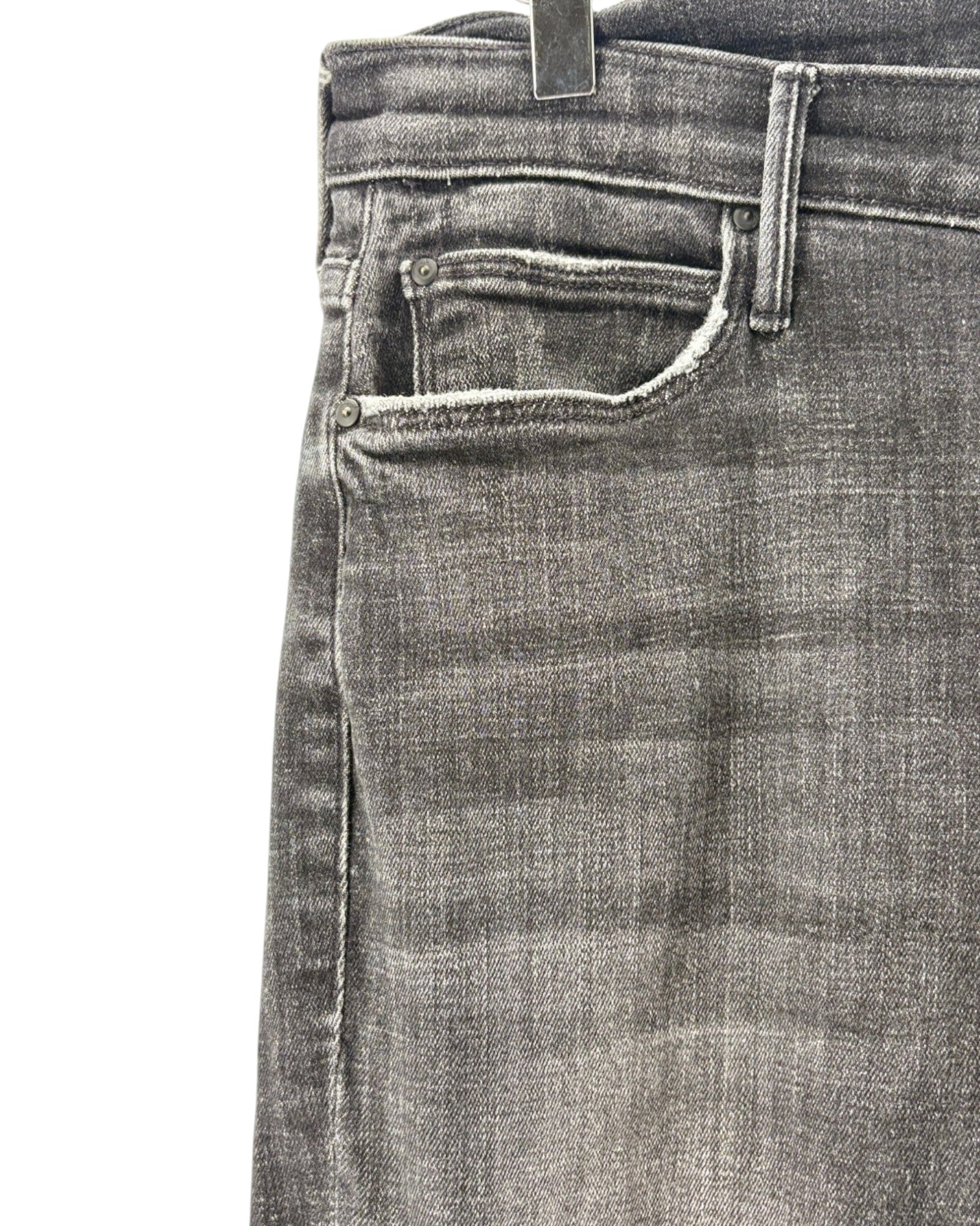 Close-up of a pair of gray washed denim jeans showing the front pocket, waistband, and fabric texture on a white background.